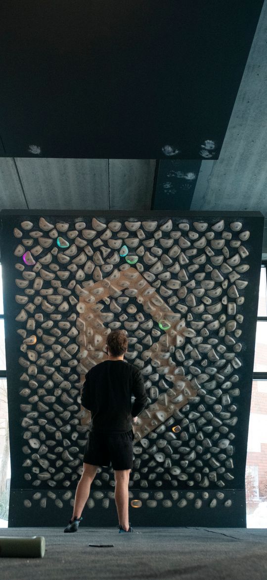A climber reading a training board before an attempt